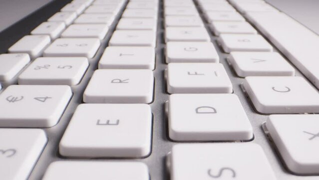 Close-up of Buttons of Wireless White and Silver Keyboard