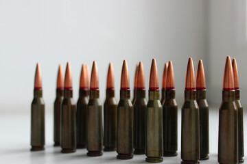 Mild steel core ammunition for automatic rifle lined up on a white background with soft focus stock...