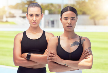 Women, athlete and focus at training ground or running club together. Confidence, arms crossed and girl teamwork at sports field or fitness facility to prepare for competition or contest