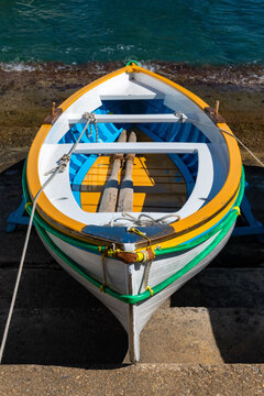 Colorful wooden fisher boat in the harbour Marina Grande on Capri Island Italy. Oars, ropes and bright colors, typical for small boats that bring tourists into the famous Blue Cave “Grotta Azzurra“.