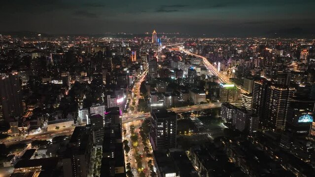 Hyperlapse flight showing traffic on lighting roads in Taipei City by night - drone time lapse
