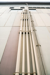 Obraz premium Pipes on a grunge concrete wall.Rows of conduit pipes on a old wall with copy space. Selective focus.