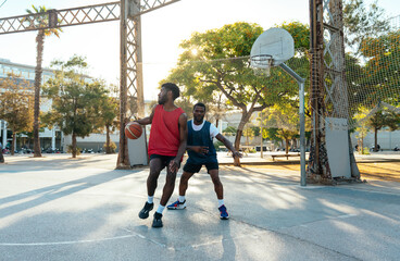 One vs one basketball game training at the court. Cinematic look image of friends practicing shots and slam dunks in an urban area © oneinchpunch