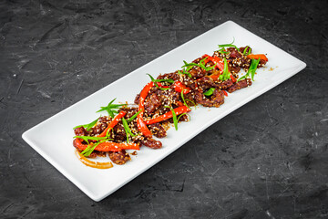 Sichuan roasted beef on a black background