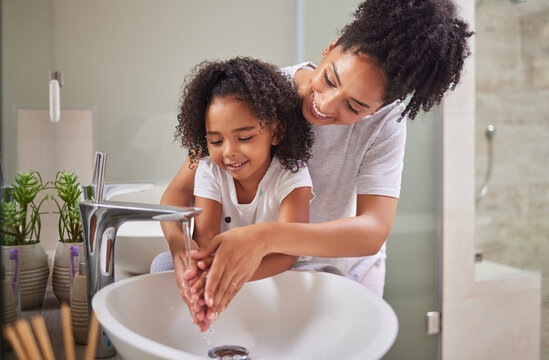 Family, washing hands and child with mom rinsing, cleaning and good hygiene against bacteria or germs for infection or virus protection in bathroom. Girl kid with woman for health and cleanliness
