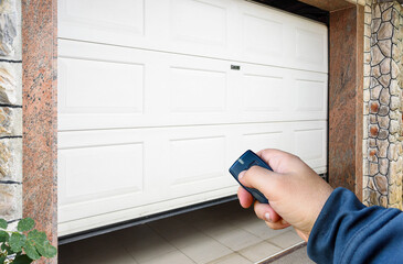 Garage door PVC. Hand use remote controller for closing and opening garage door