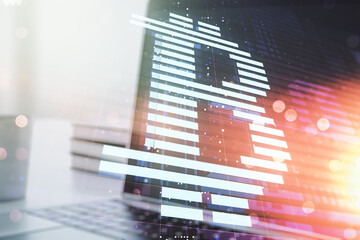 Double exposure of creative Bitcoin symbol with modern laptop on background. Cryptocurrency concept