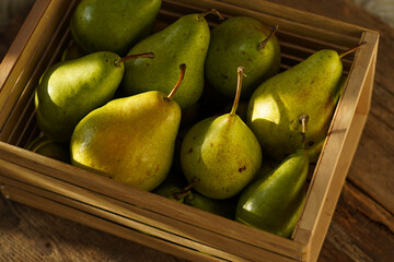 Pears on a wooden background. Fruit harvest. Autumn still life. Pear variety Bera Conference.