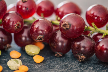 Red currant berries on a textured surface, macro shot.