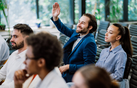 Cinematic image of a conference meeting. Business people sitting in a room listening to the motivator coach. Representation of a Self growth and improvement special event