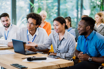 Cinematic image of a conference meeting. Business people sitting in a room listening to the motivator coach. Representation of a Self growth and improvement special event