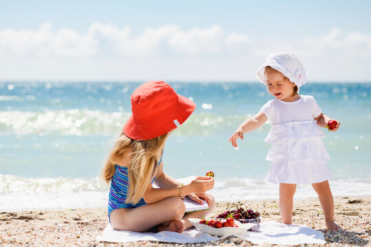 Two girls sisters have sea beach picnic