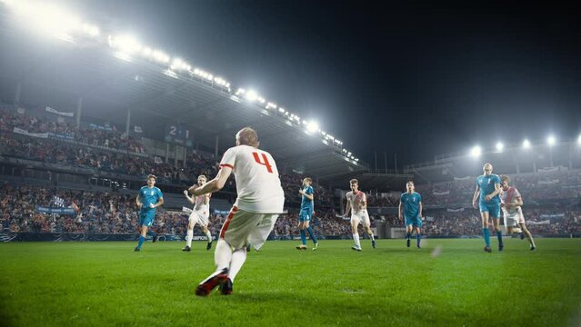 Football Championship: White Team Forward Hits the Ball and Scores Perfect Goal in Slow Motion. Goalkeeper Jumps and Fails to Catch, Protect Goals. Crowd of Fans Cheers. Playback in Cinematic Front