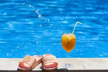 Summer vibes with cocktail, pool and shoes