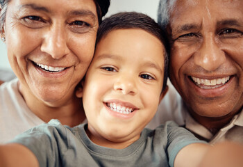 Boy take selfie with happy grandparents, together in closeup or zoom portrait in house. Latino male...