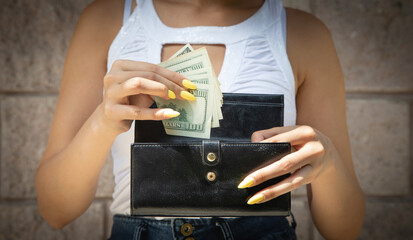 Woman hands with wallet and money.
