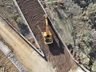 Aerial view of Construction excavator of yellow sand on the construction site in a quarry for quarrying.