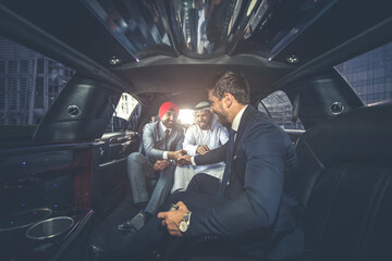 Business team talking about future plans in Dubai in the limousine
