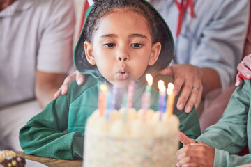 Birthday, cake and girl with candles, happy and excited at a party celebration with family....