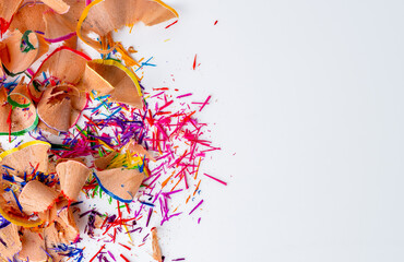  top view of wooden color crayon pencil shavings graphite from sharpener on white background. .