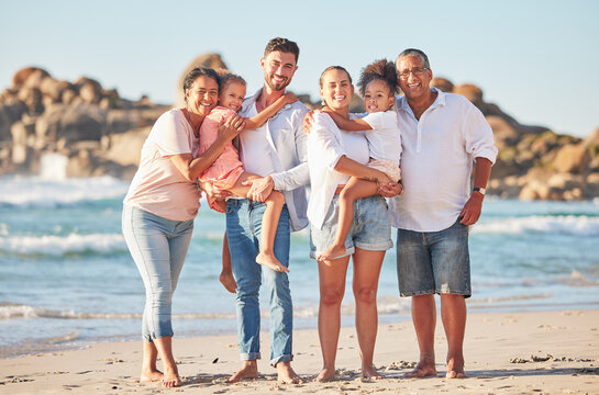 Happy Family, Portrait And Beach Summer Vacation With Happy People Bonding On Ocean Trip. Freedom, Love And Sea Travel With Interracial Family Hug, Laugh And Walking In Nature With Excited Children