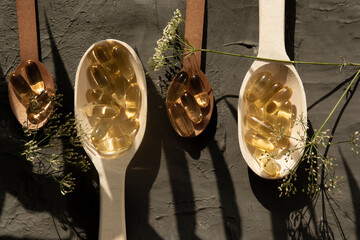 Wooden spoons containing omega 3 vitamins, sports, vitamins, healthy lifestyle, dietary...