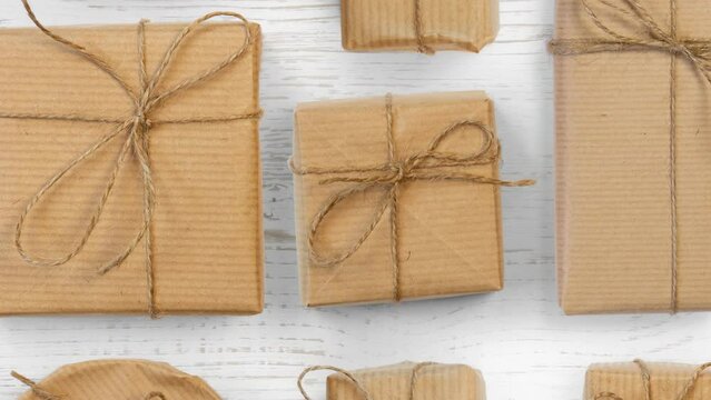 Moving group of Christmas Gifts on white wooden background. High quality 4k video.
