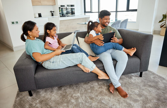 Family, children and technology with a girl, sister and parents streaming an online subscription service in a living room. Tablet, laptop and internet with a mother, father and daughters in the home