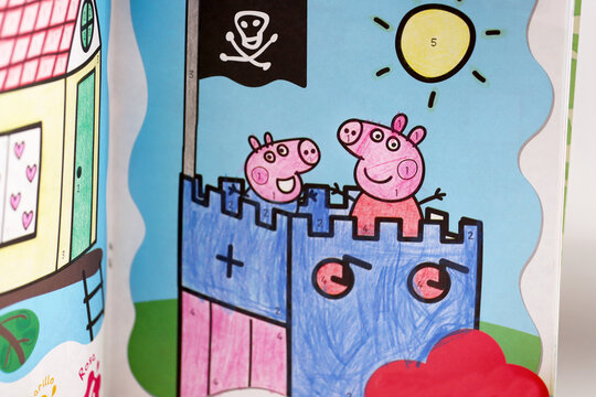 Coloring book for children. Drawing painted by children with colored pencils. Magazine for children of the character Peppa Pig. Peppa, George, Daddy Pig and Mummy Pig in their family car. Cartoon