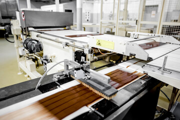 Conveyor belt line of chocolates sweets in food factory