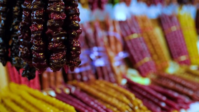 Colored Churchkhela on the East Street Market. Traditional Georgian dessert food. 