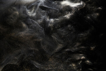 Golden sparkling abstract background, luxury black smoke, acrylic paint underwater explosion, cosmic swirling ink © amixstudio