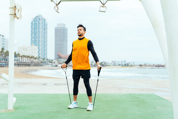 Young athlete training in the morning on the beach at the gym. outdoor. Representation of sport and...