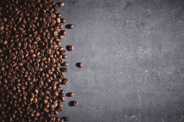 Roasted coffee beans on gray background