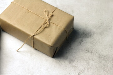 Gift boxes wrapped in brown recycled paper on the table, new year gifts, birthday gifts, brown...