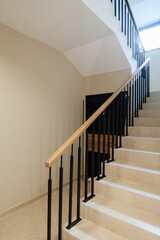 new stylish tile stairs with black metal railings in the house