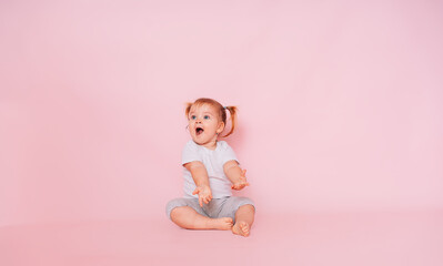Wow. Studio shot of an emotional charming little girl, surprised and shocked, showing a truly...