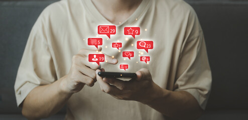 Chat and Red notification on smartphone with virtual social media icon. Man using smartphone on vacation with hologram. Social media and digital online concept.