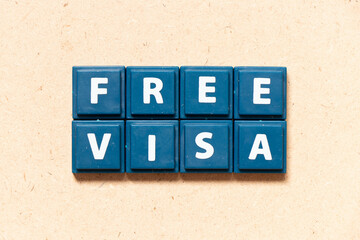 Tile letter in english word free visa on wood background