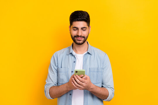 Portrait Of Young Businessman Using Phone Find New Contacts It People Isolated On Yellow Color Background