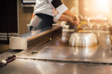 Hand of man take cooking of meat with vegetable grill, Chef cooking wagyu beef in Japanese teppanyaki restaurant