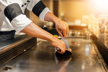 Hand of man take cooking of meat with vegetable grill, Chef cooking wagyu beef in Japanese teppanyaki restaurant