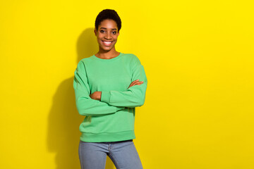 Photo of sweet pretty short hair human wear casual sweater arms crossed empty space isolated yellow color background