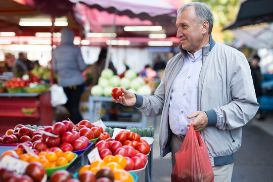 Middle Aged Man Buying Tomatoes