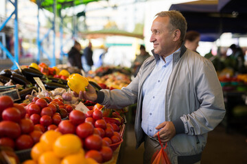 Man buying peppers in market