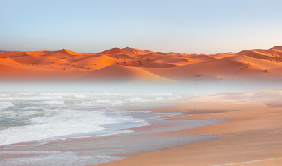 Namib desert with Atlantic ocean meets near Skeleton coast, Full moon in the background - Namibia,...