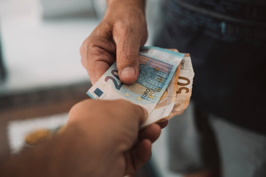 Close Up Of People Exchanging Cash Banknote Money. Concept Of Giving And Taking Euros. Economy And Business. Present And Loan Back. Banking Financial. Paying Bills Or Credit Action. One Man Give Money