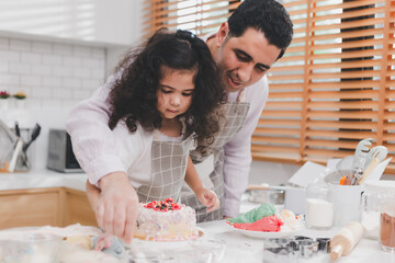 Happy family Middle eastern preschool African Arab kid person make cake cooking in kitchen, Father and daughter prepare decoration cake with fun educate. Single dad spend quality time with his kid.