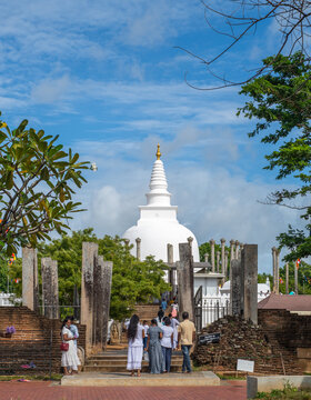 Anuradhapura, Sri Lanka - 05 15 2022: Thuparama Dagaba and the pilgrims in the sacred city of Anuradhapura,