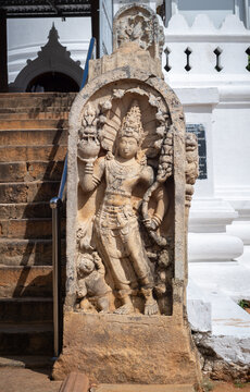 Guard stone in Thuparama temple entrance, snake god and two dwarfs carved in one stone.